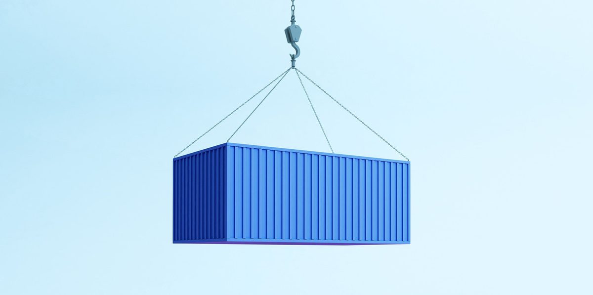 Shipping container being lifted by a crane hook